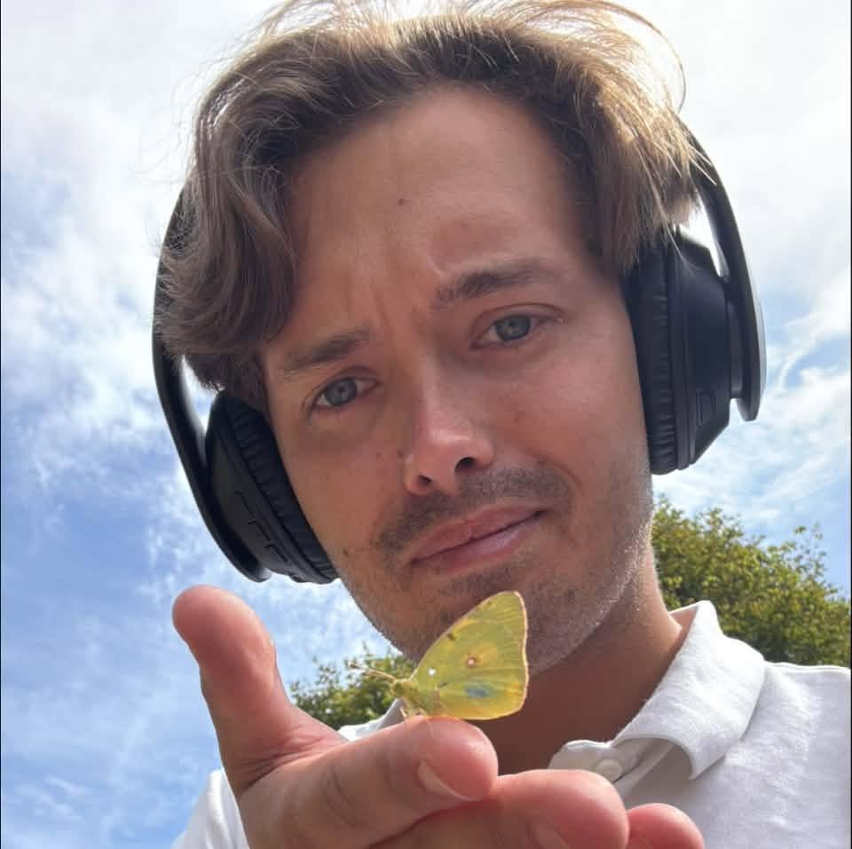 A picture of George Hancock holding a butterfly